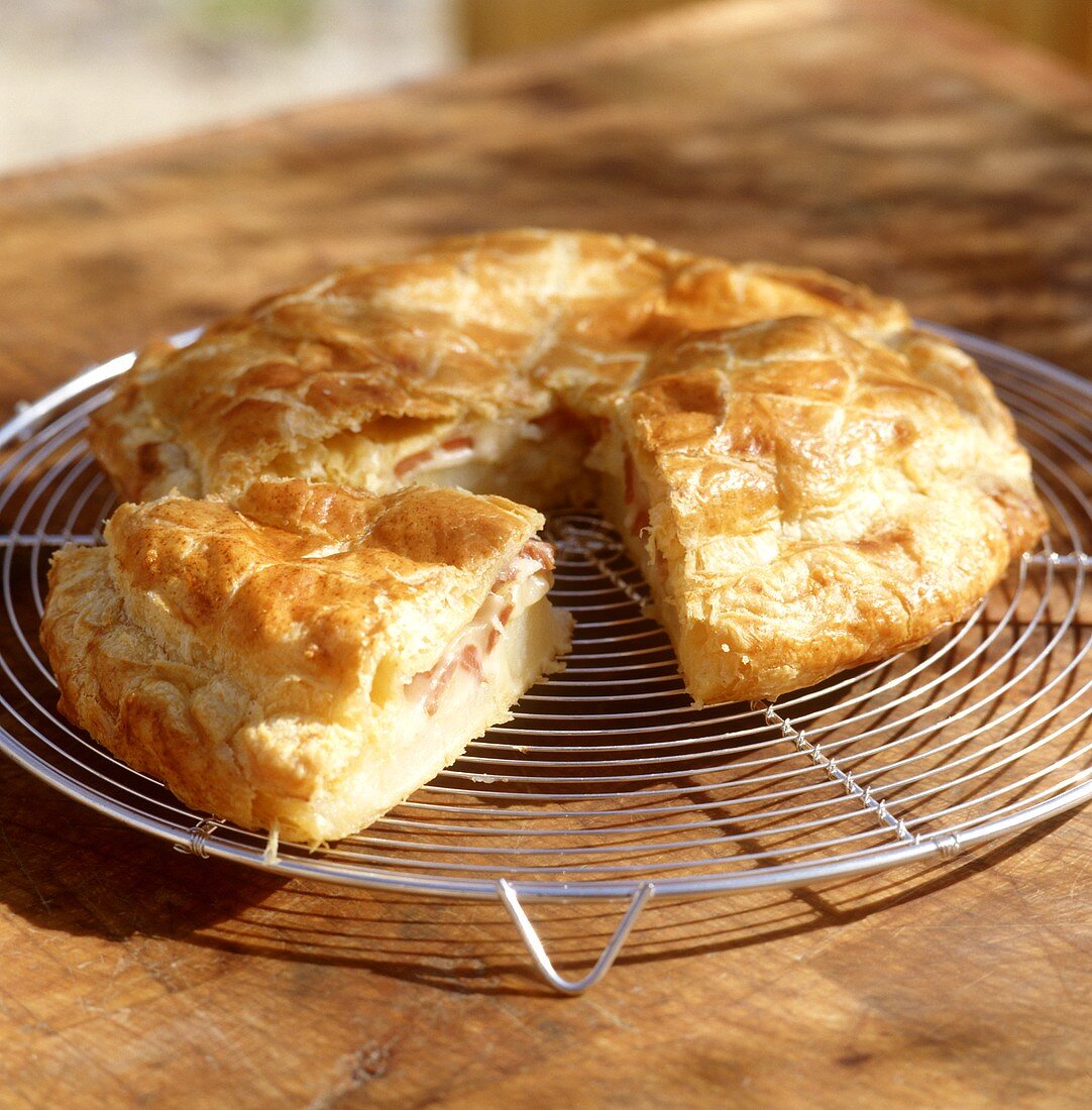 Savoury potato and cheese pie on cake rack