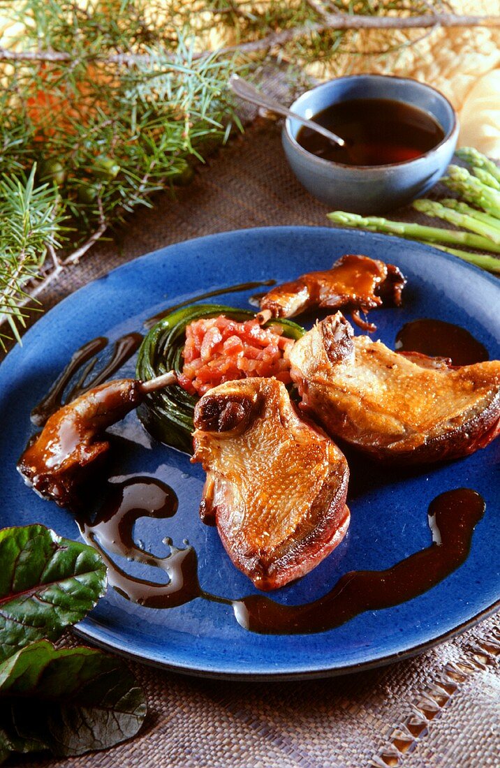 Duck confit with asparagus and red wine sauce