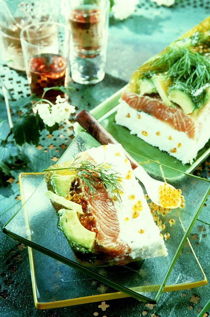 Salmon and avocado terrine with caviare (a slice cut)