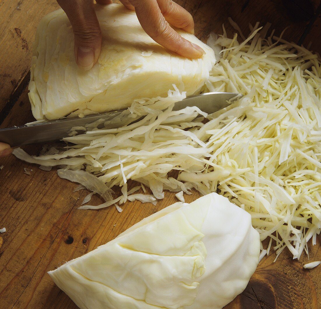 Cutting white cabbage into strips