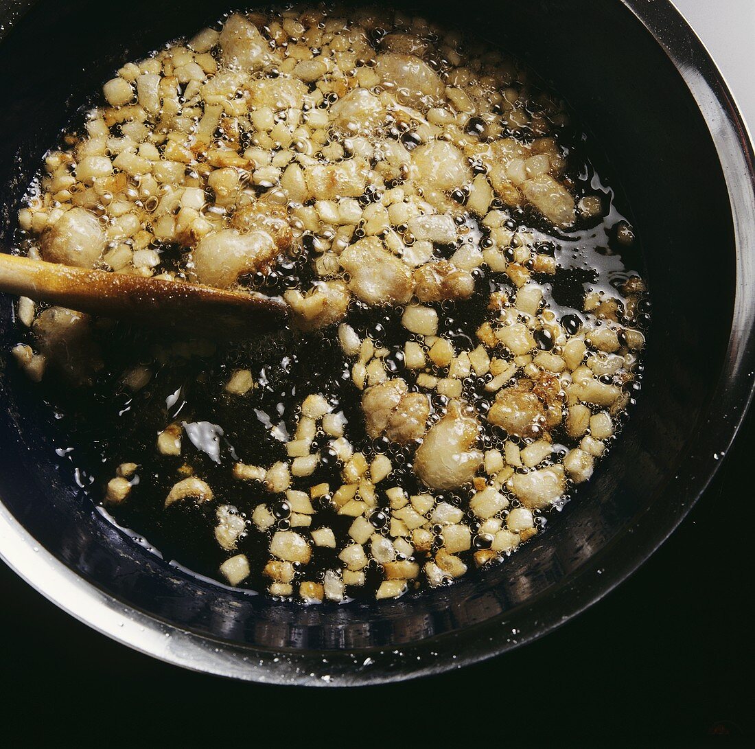 Frying bacon until the fat runs