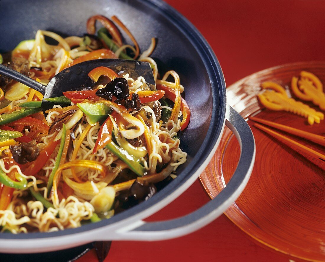 Egg noodles with mixed vegetables in wok
