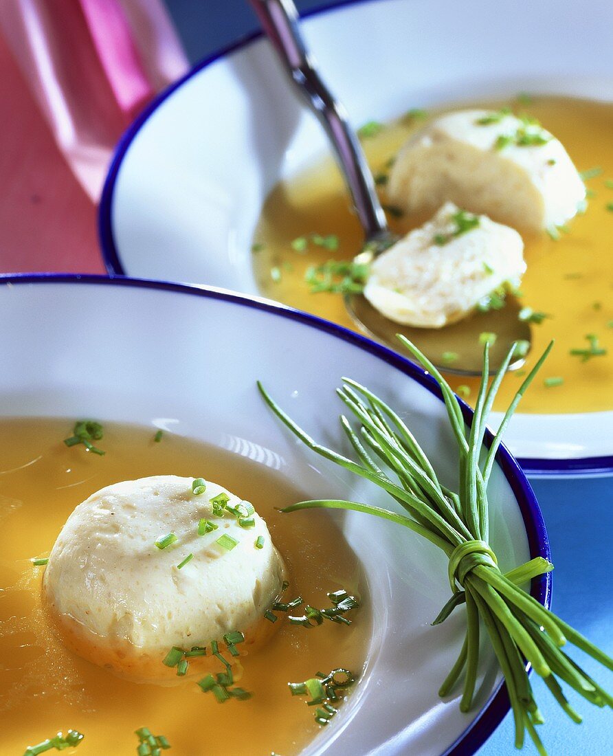 Chicken flan in broth with snipped chives