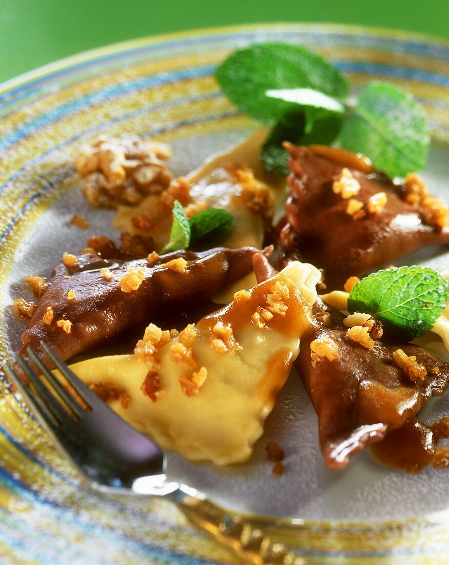 Sweet ravioli with nuts and mint leaves