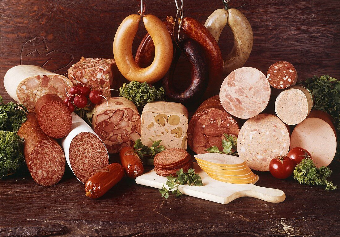 A selection of sausages on dark wooden background