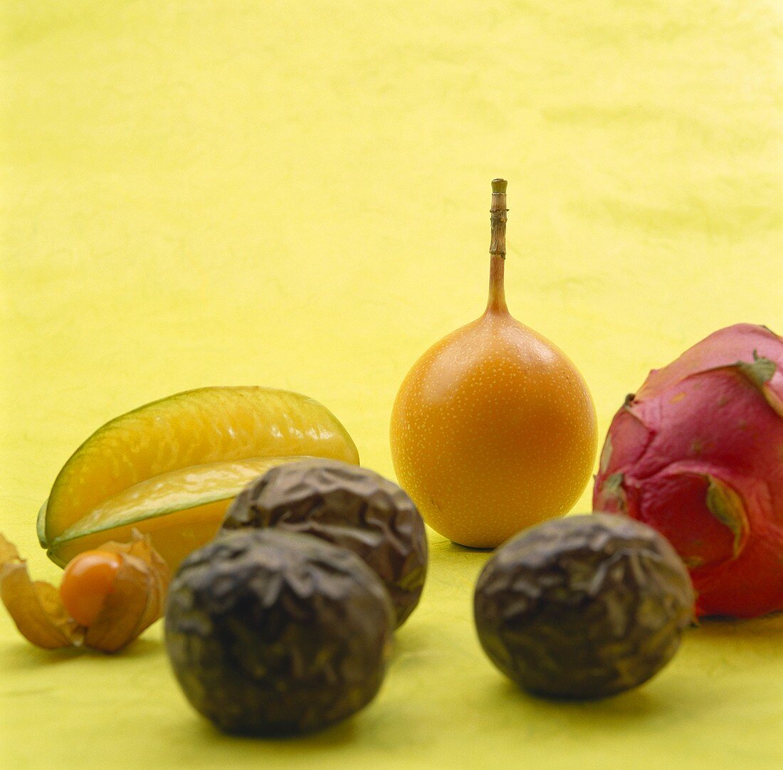 Various exotic fruits on pale green background