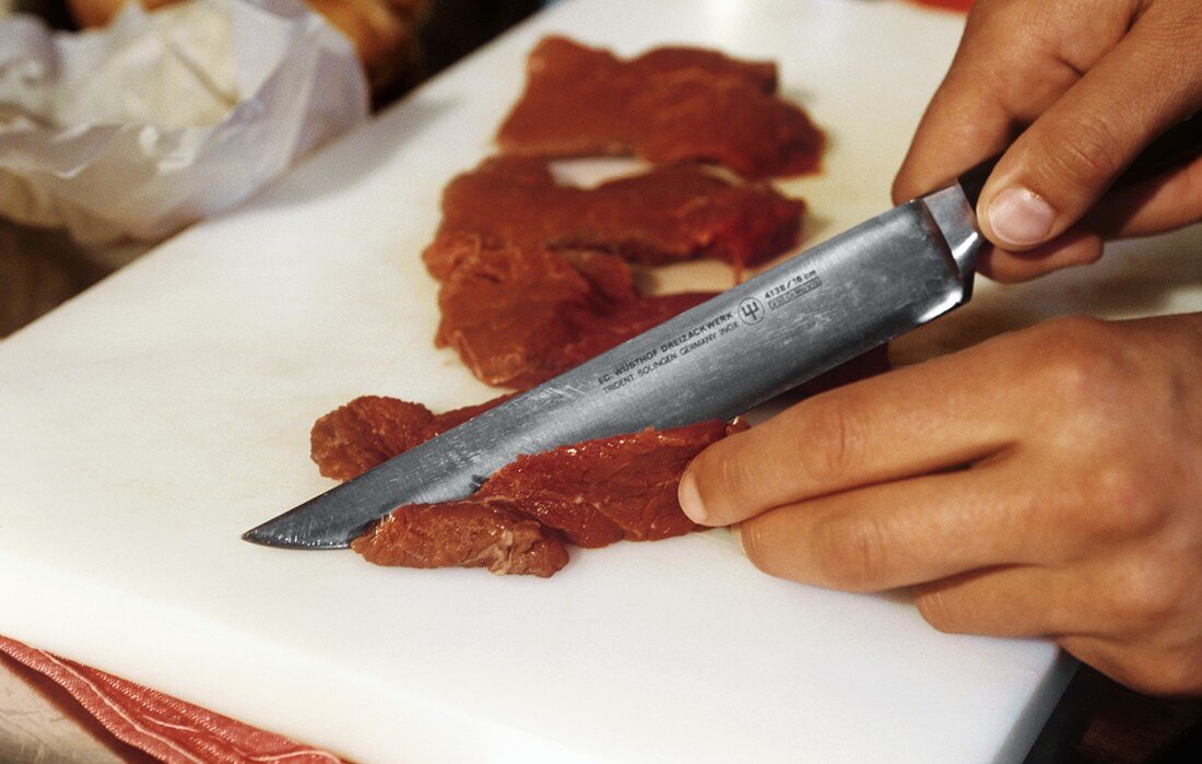Cutting beef fillet into strips
