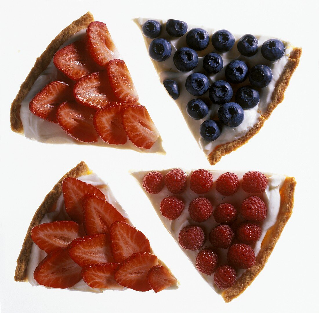 Four pieces of tart strawberry, raspberry and blueberry