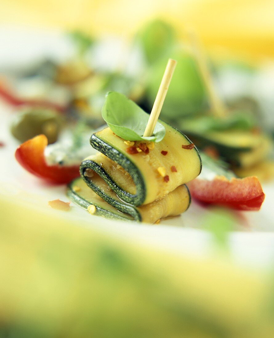 Marinated courgettes with basil on toothpick