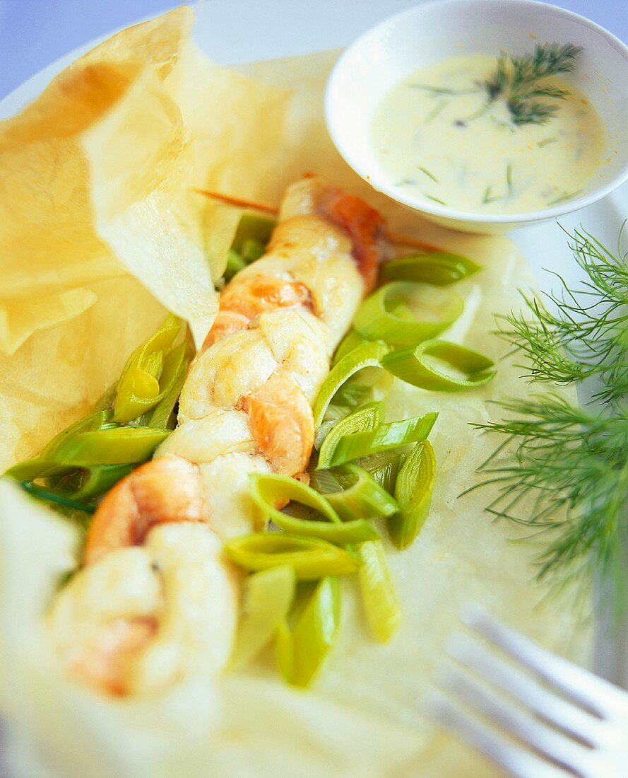 Fish plait on spring onions with dill sauce