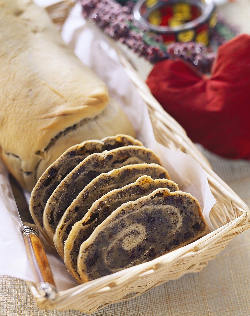 Poppy seed strudel, partly slices, in bread basket