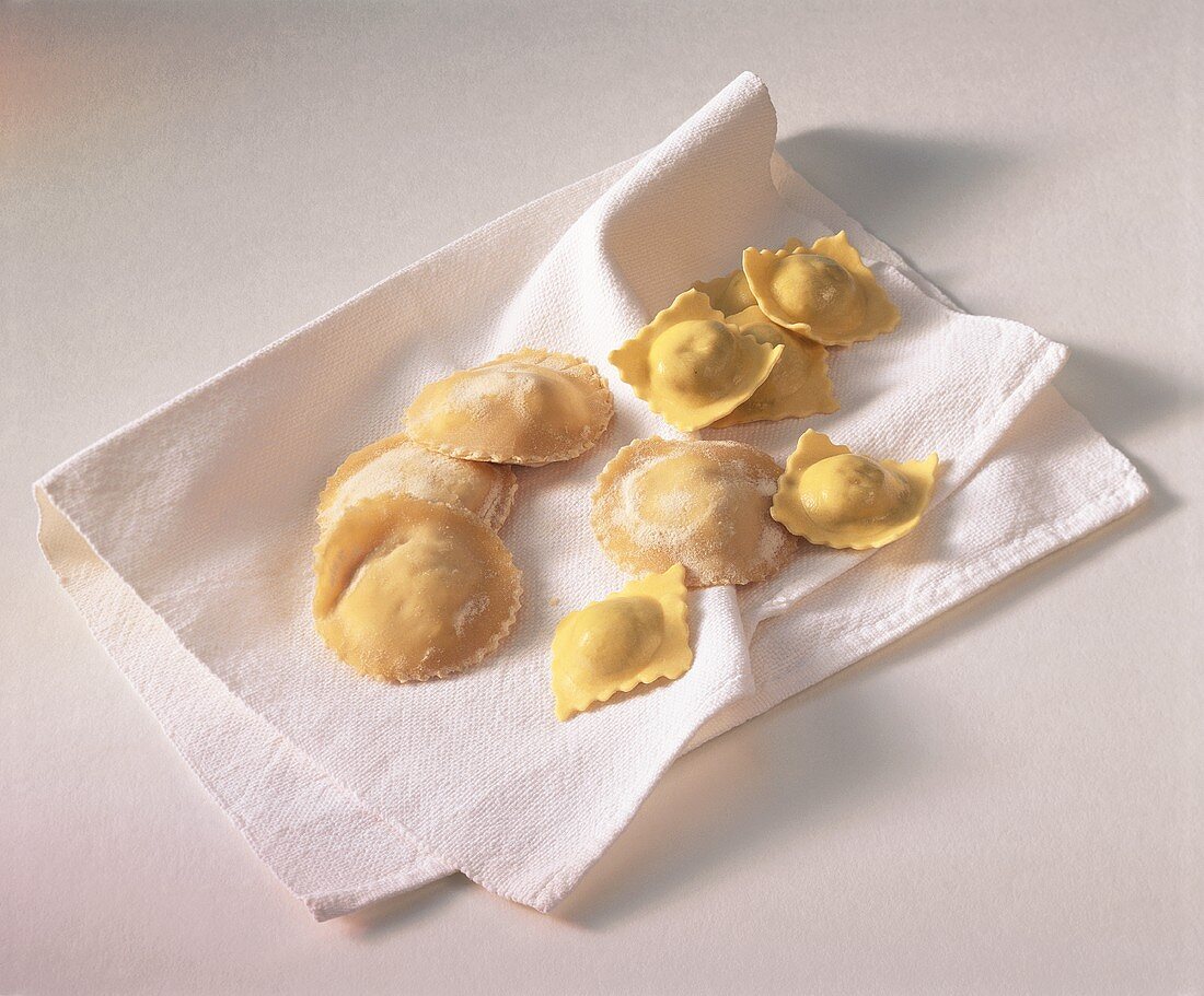 Home-made ravioli on white cloth