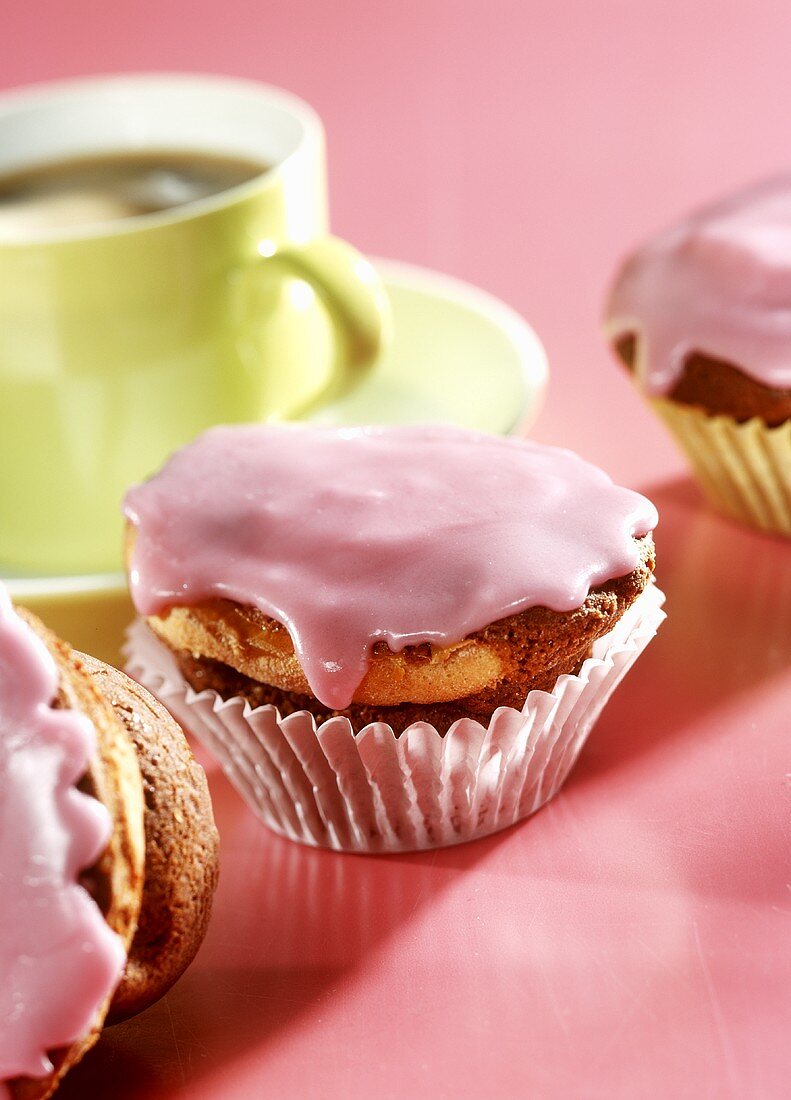 Cappuccino and cherry muffins with pink icing