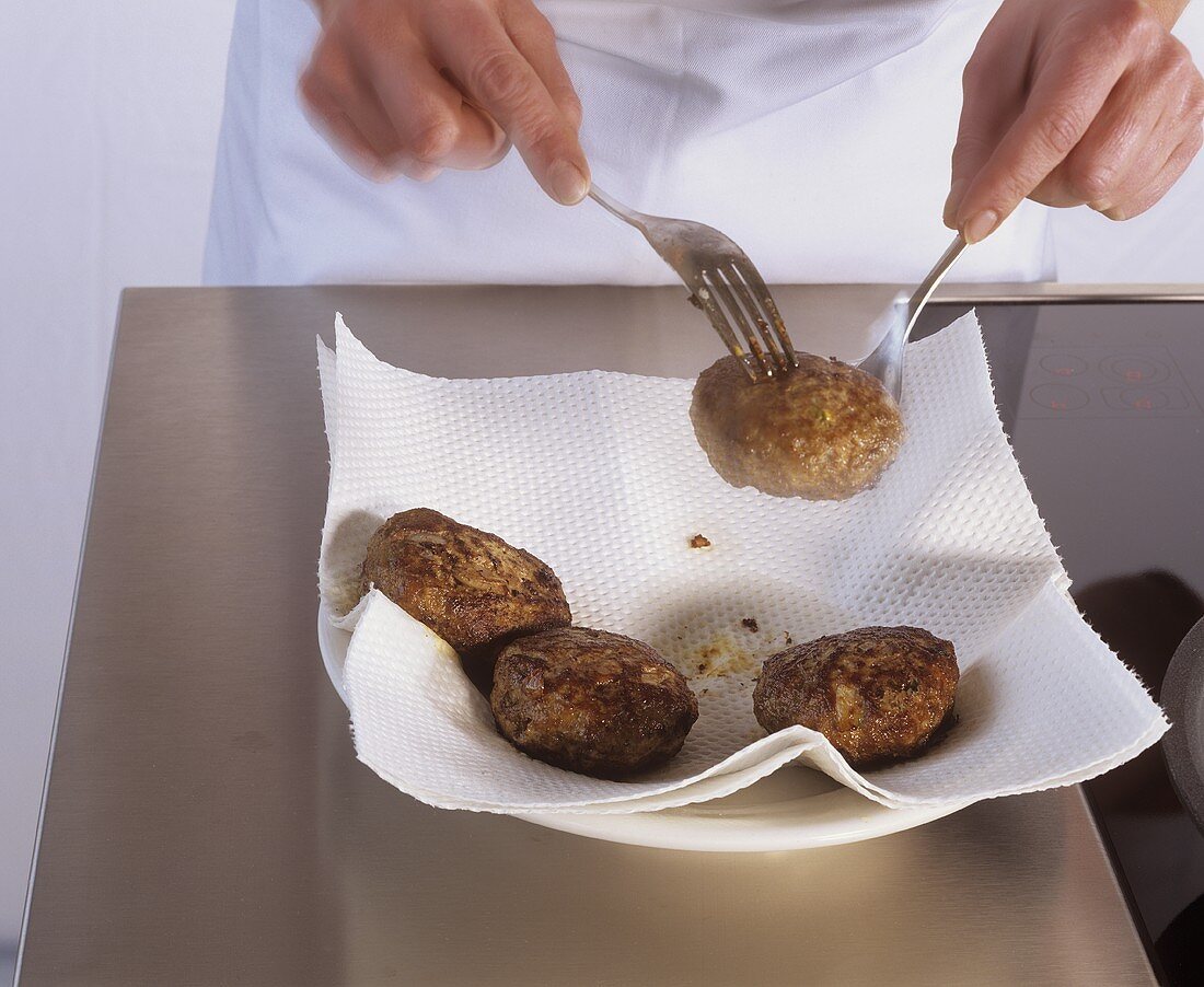 Draining rissoles on absorbent kitchen paper