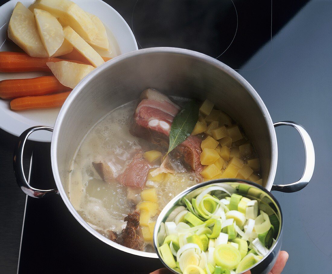 Cooking soup vegetables with bacon