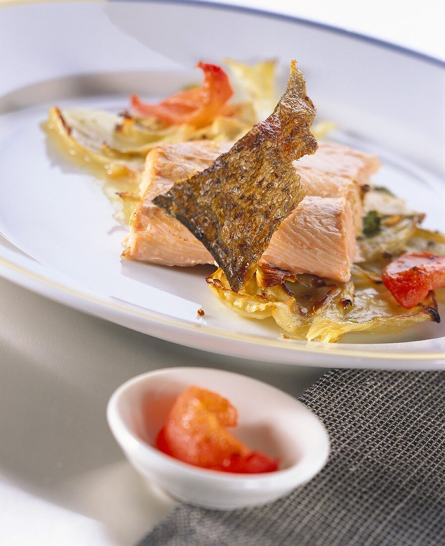 Fried salmon trout with fennel and tomatoes