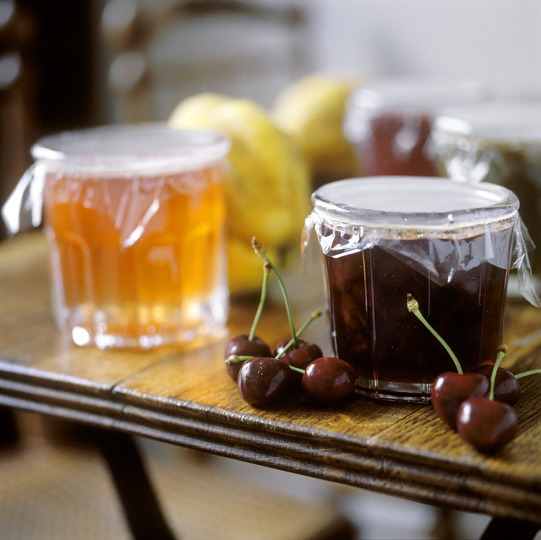 Cherry jam beside jar of quince jam