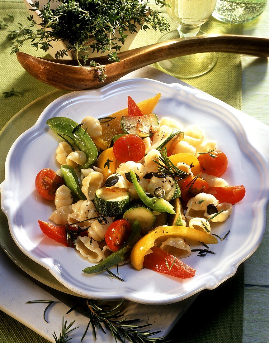 Pasta shells with summer vegetables and pumpkin seeds