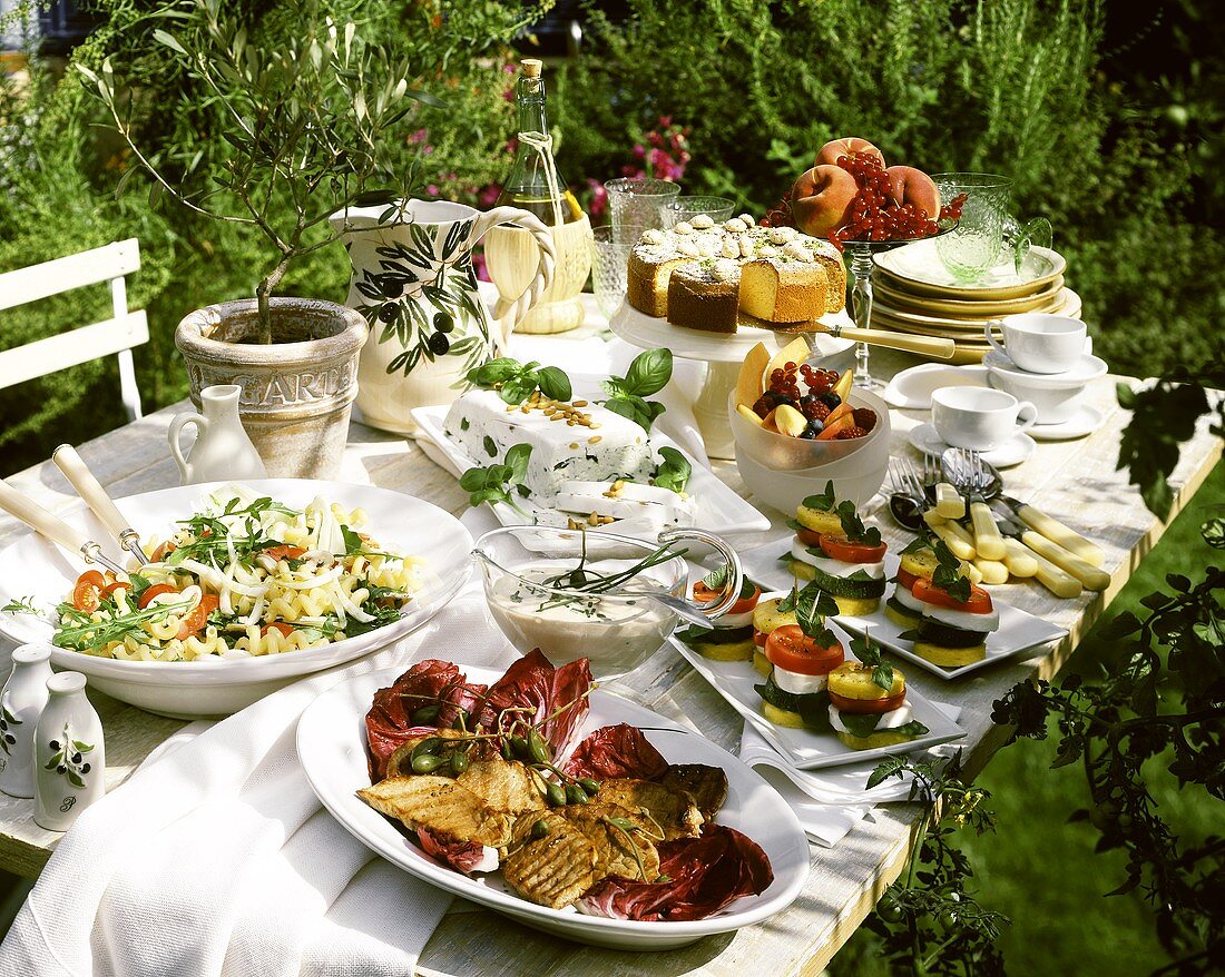 Summer buffet on garden table in open air