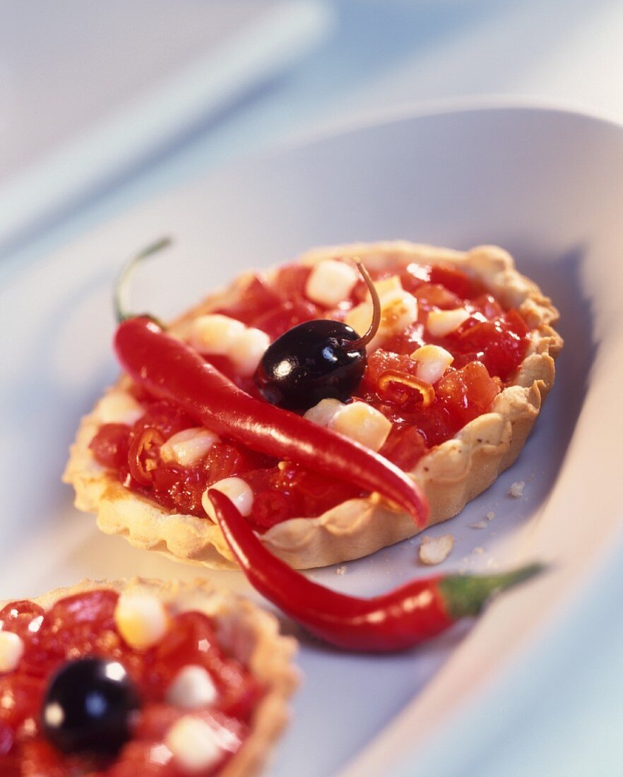 Spicy tomato and chili tartlet with olive and mozzarella