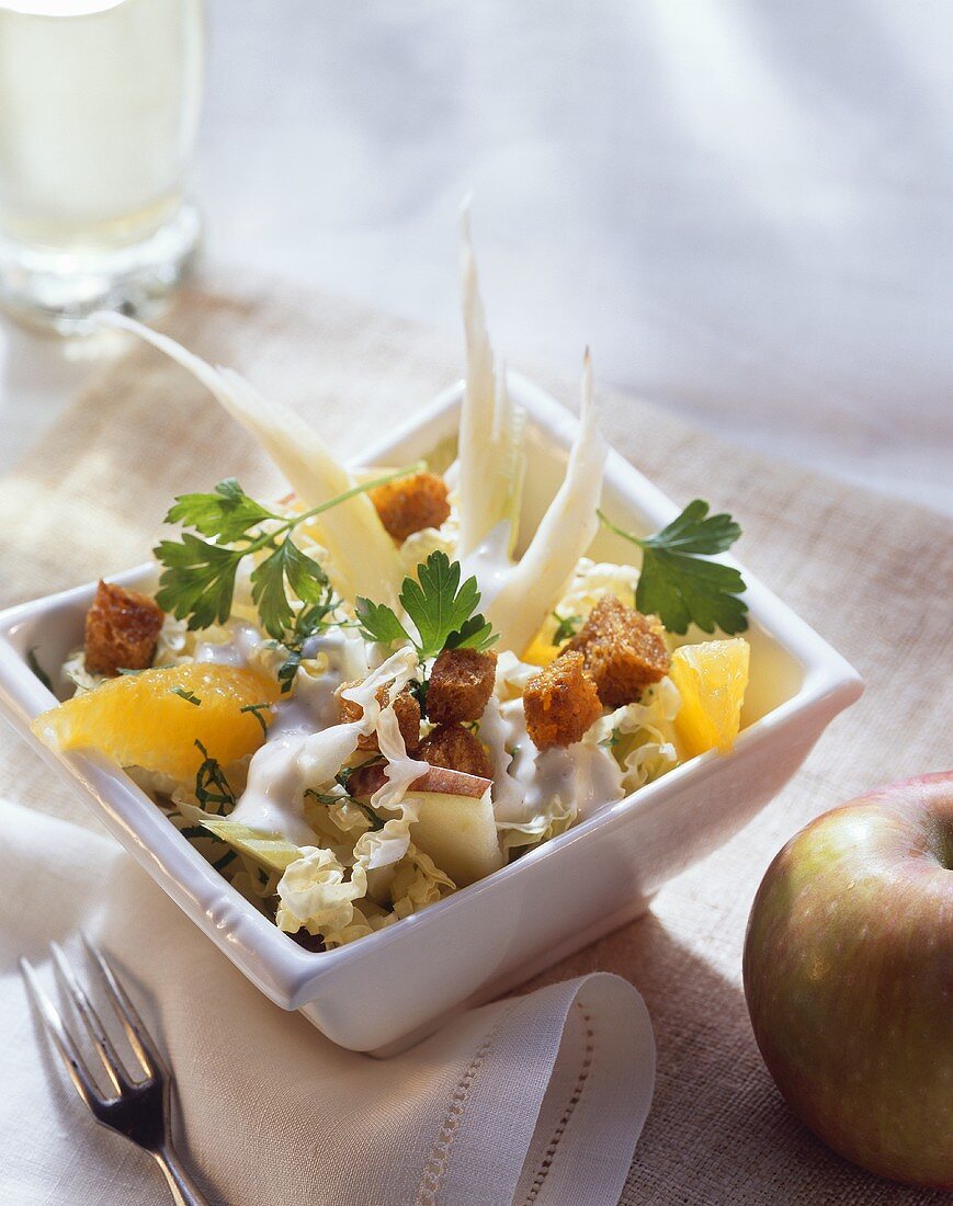 Celery and Chinese cabbage salad with fruit and croutons
