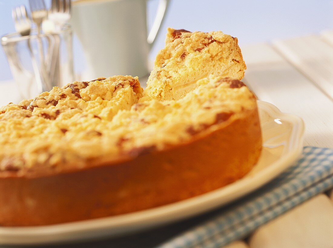 Apple and marzipan crumble tart with a piece cut out