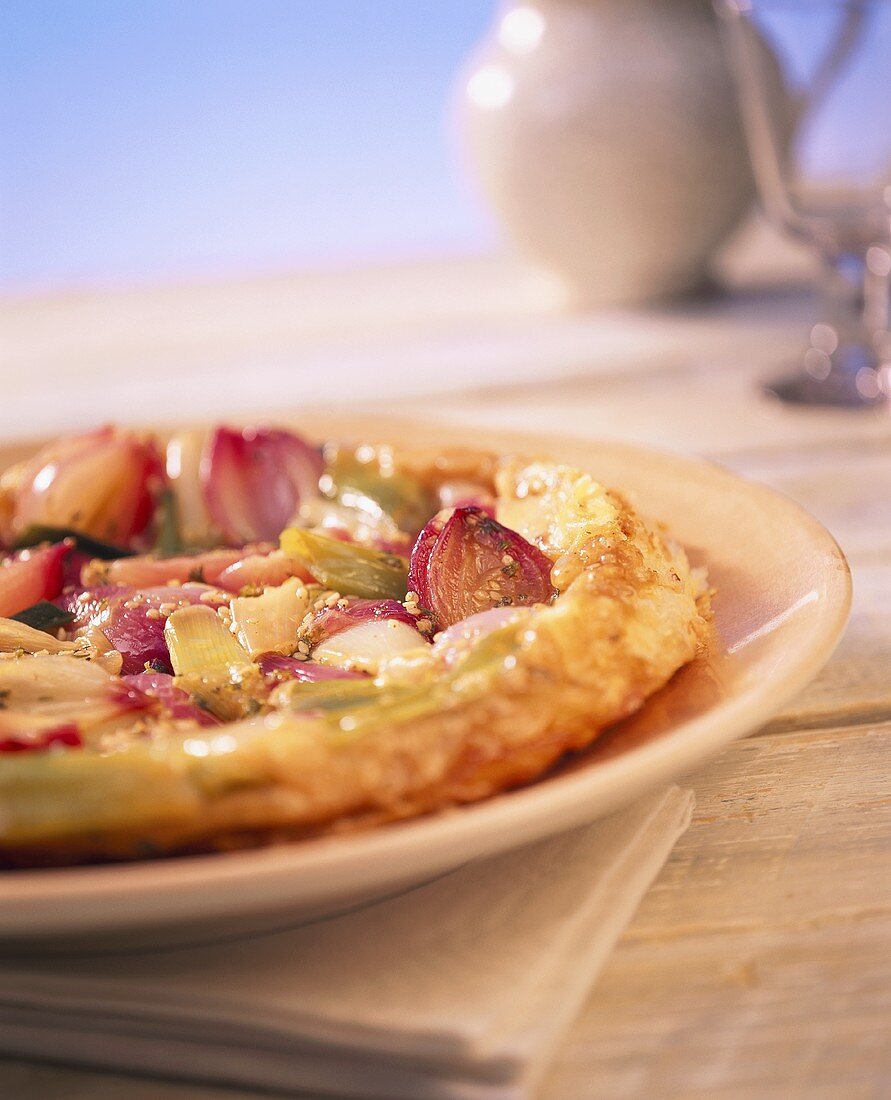 Onion tart with puff pastry and sesame