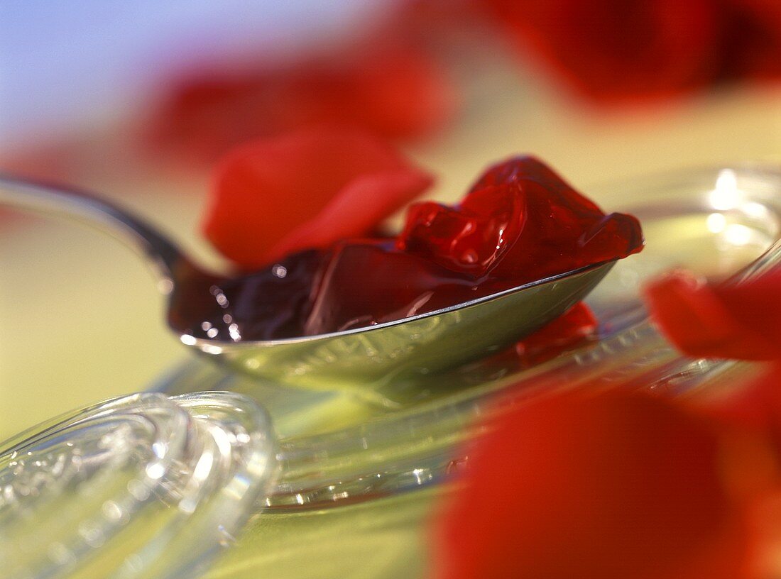Redcurrant and rose petal jelly on spoon
