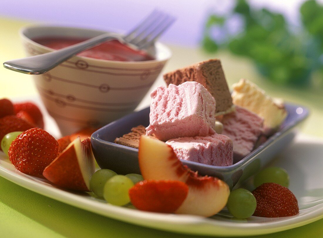 Ice cream and fruit fondue with raspberry sauce