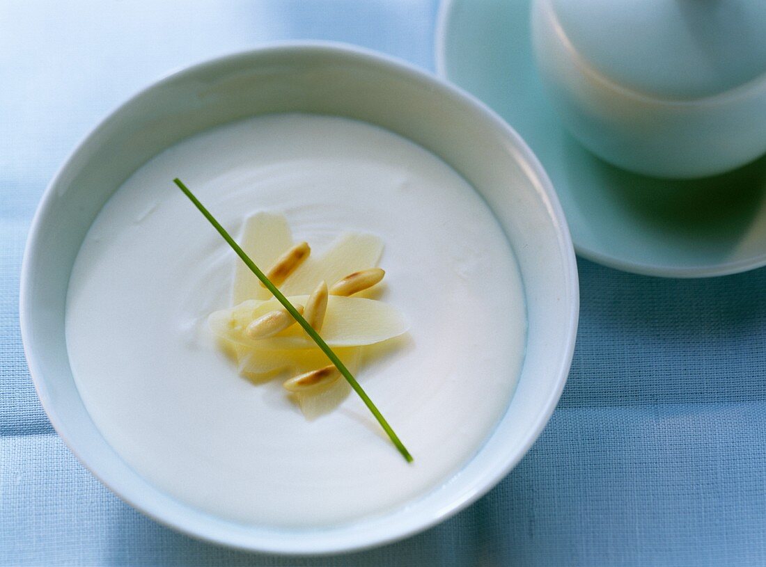 Creamed asparagus soup with pine nuts