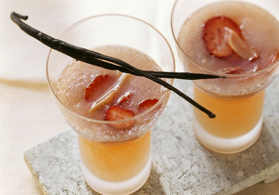 Rhubarb and strawberry soup in glasses; vanilla pod