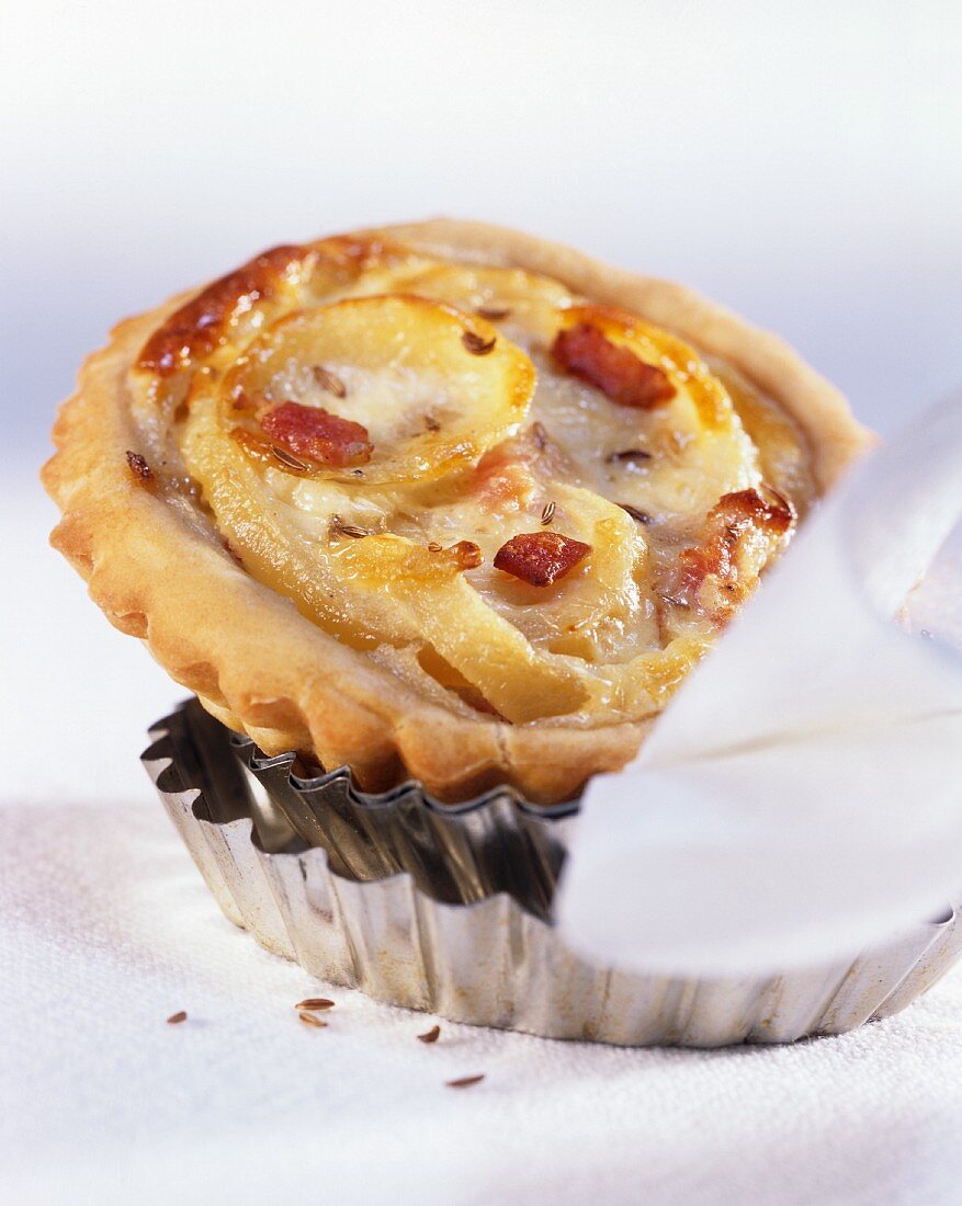 Onion tart with bacon on baking tins