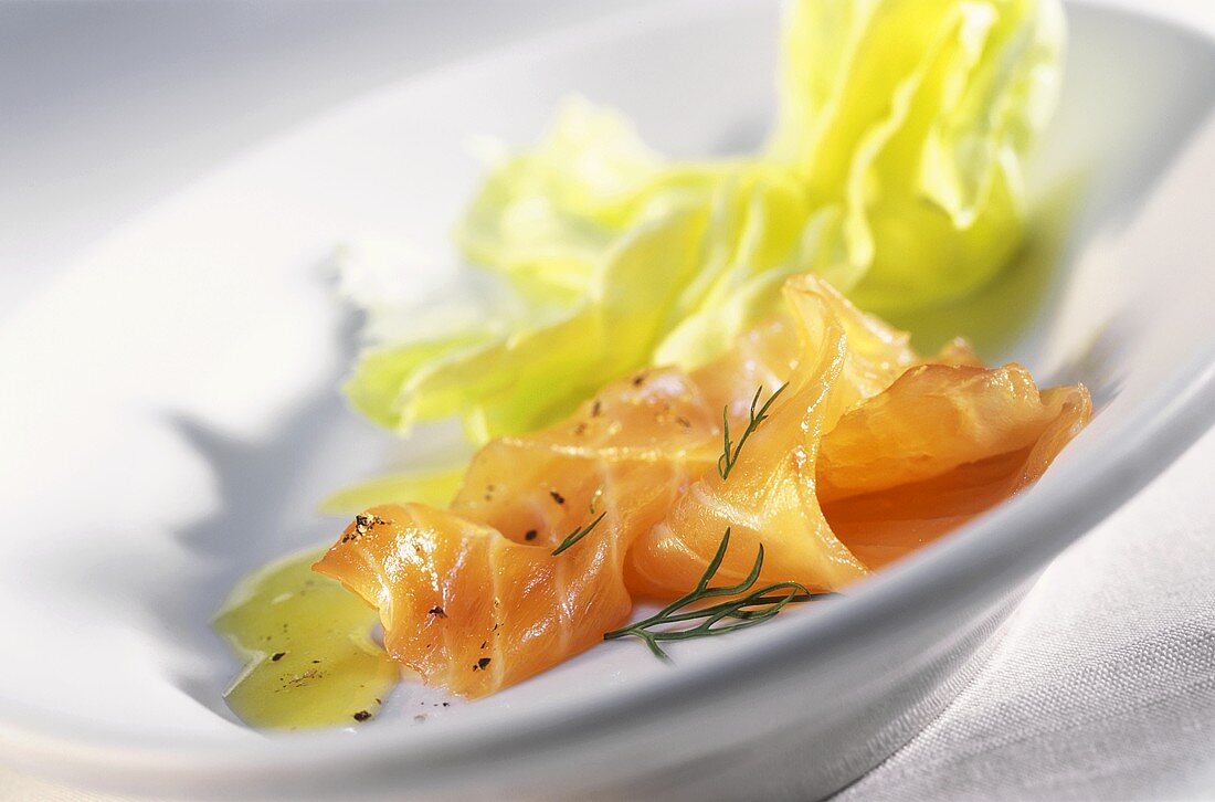 Smoked salmon with lettuce leaf, pepper and dill