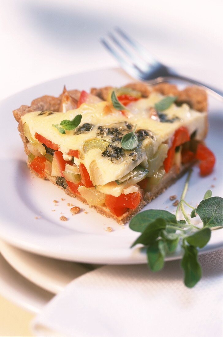 Piece of buckwheat tart with cheese and herbs