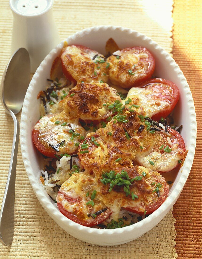 Baked tomatoes on rice in baking dish