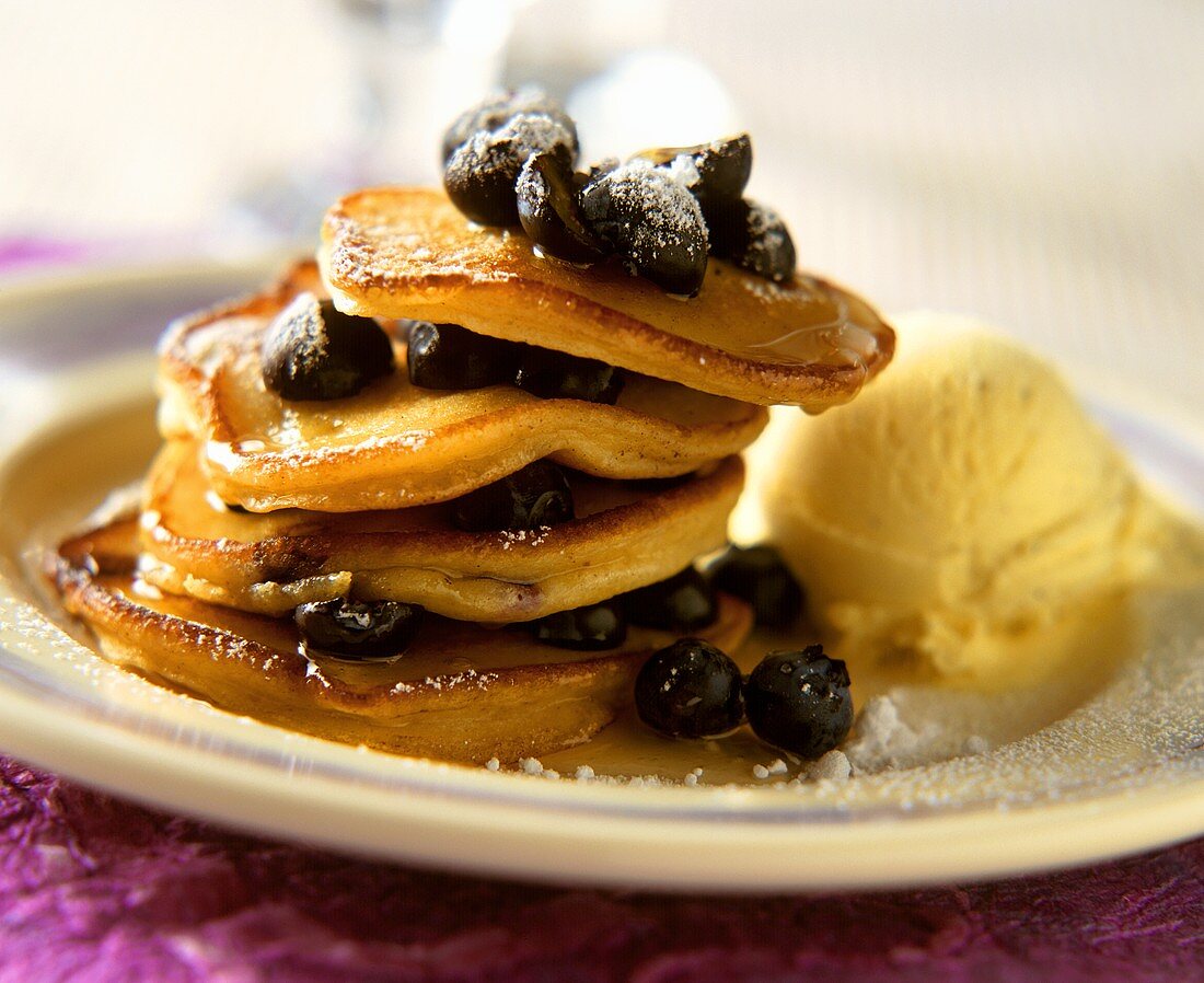 Blueberry pancakes with honey, icing sugar & vanilla ice cream