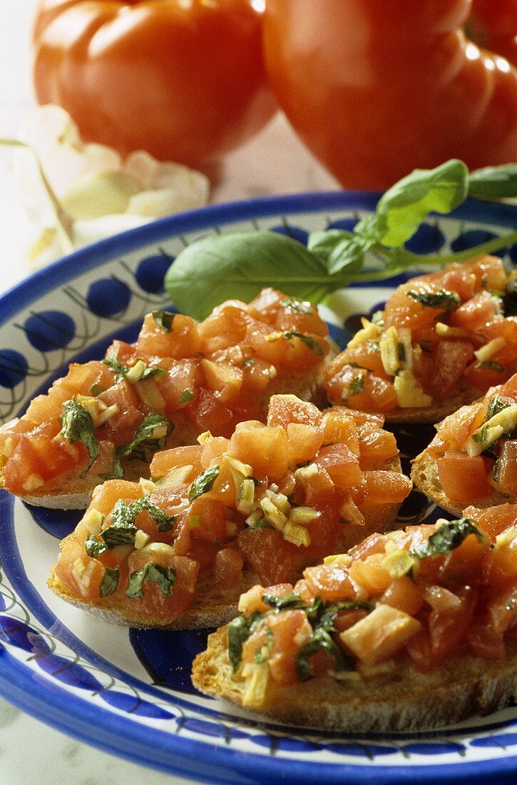 Bruschetta with chopped basil; fresh tomatoes