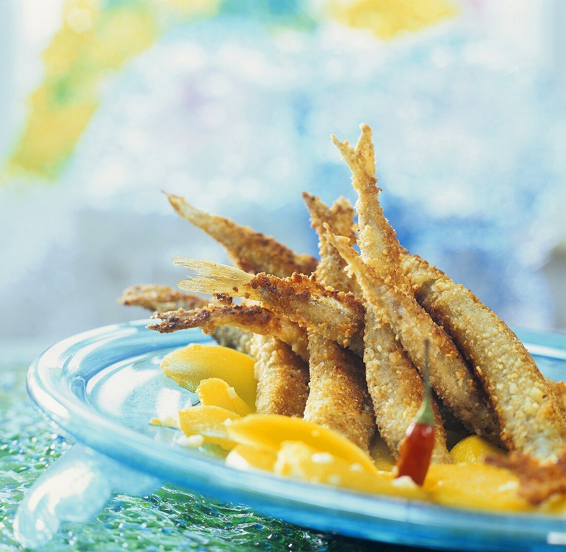 Fish (smelt) in nut crust on fruit