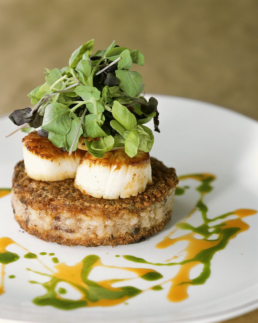 Coquilles St. Jacques on risotto burger, garnished with herbs