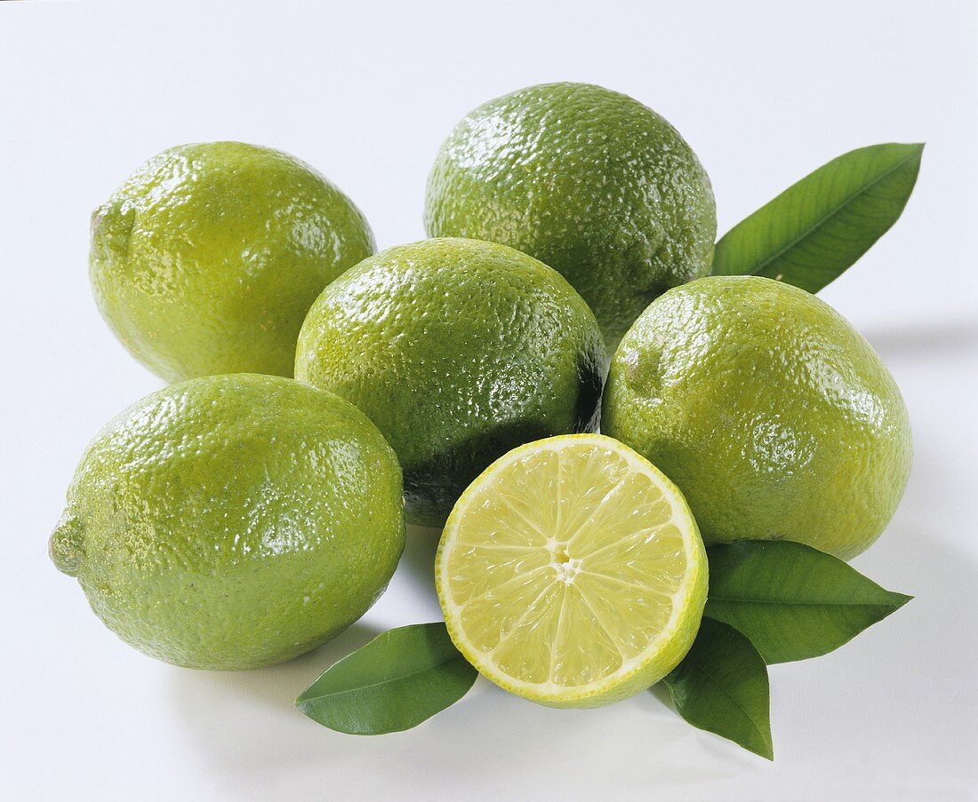 Several limes, one halved
