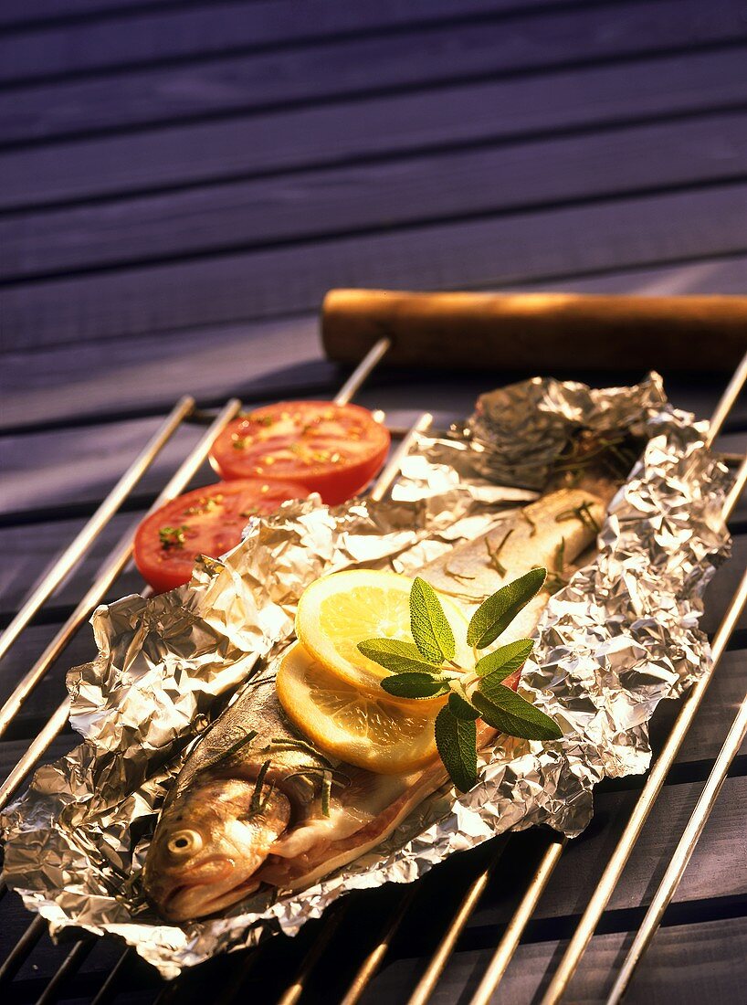 Grilled trout with sage in foil