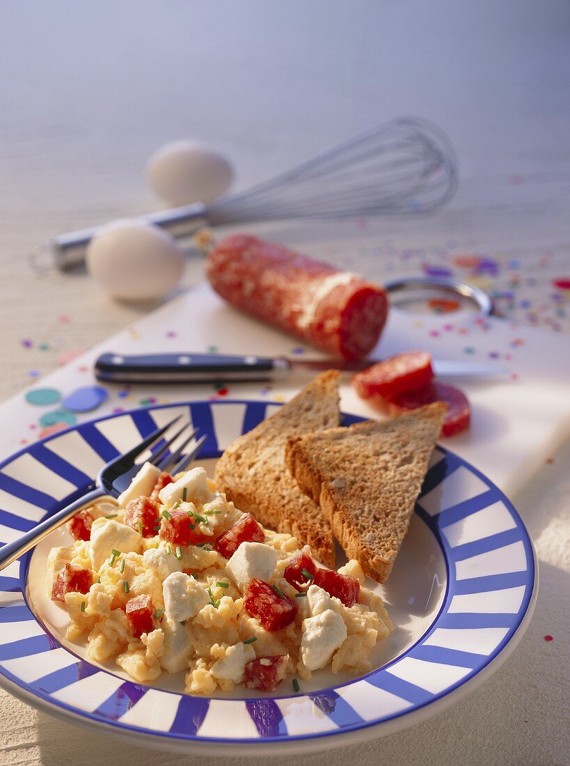 Scrambled egg with sheep's cheese, salami & wholemeal toast