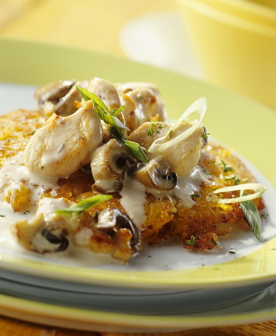 Finely chopped chicken with mushrooms on rosti