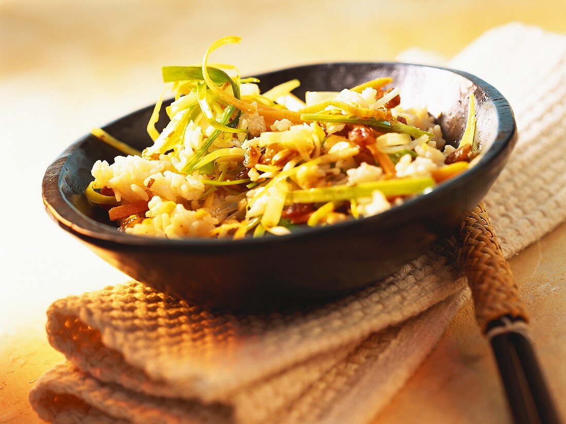 Indian coconut rice with vegetables, almonds and raisins