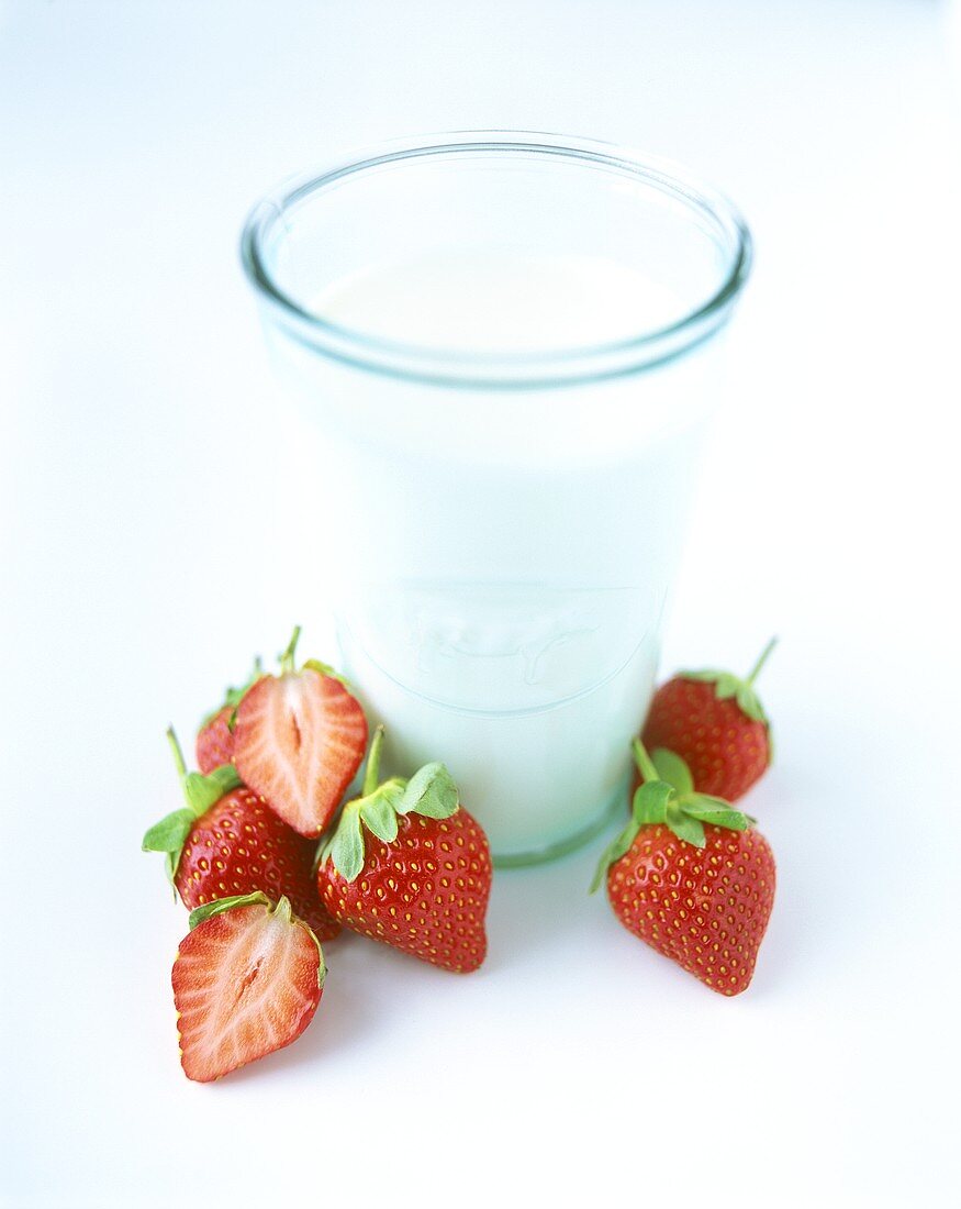 Glass of milk and fresh strawberries
