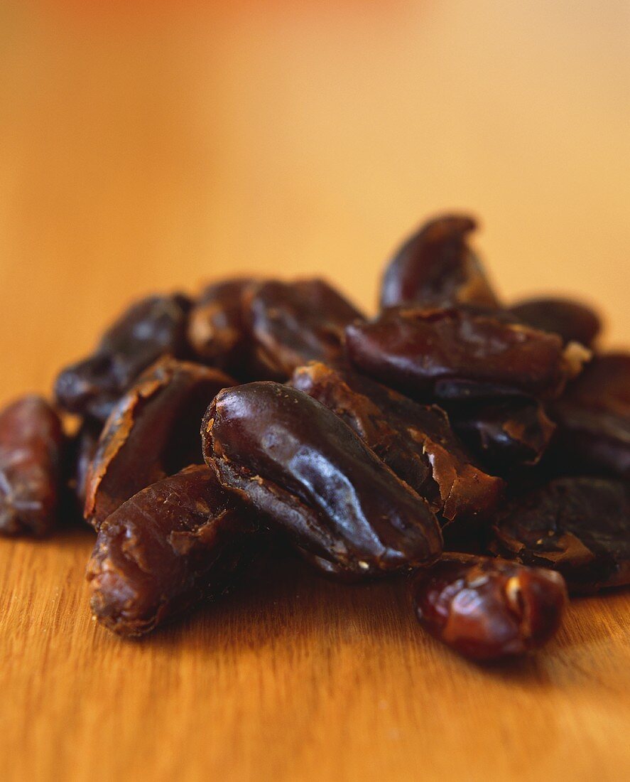 Dried dates on wooden background