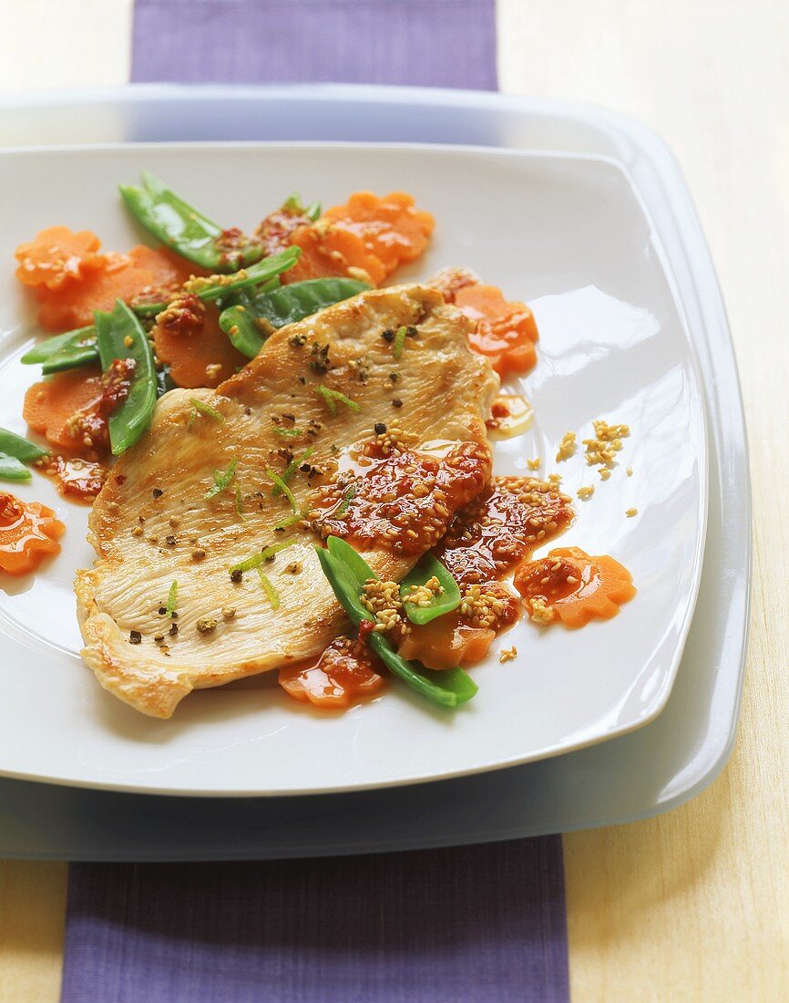 Turkey escalope on wok-cooked vegetables with chili sauce