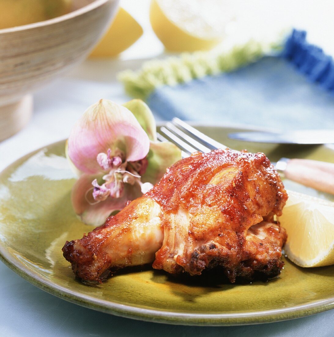 A piece of roast garlic chicken on plate (from Cuba)