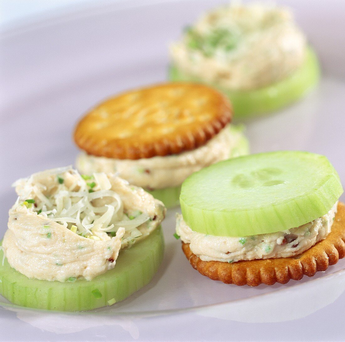 Cracker and cucumber slices with ham mousse