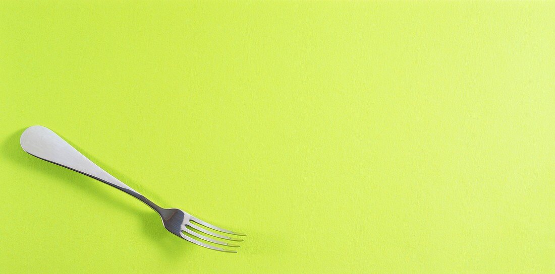 Fork on green background